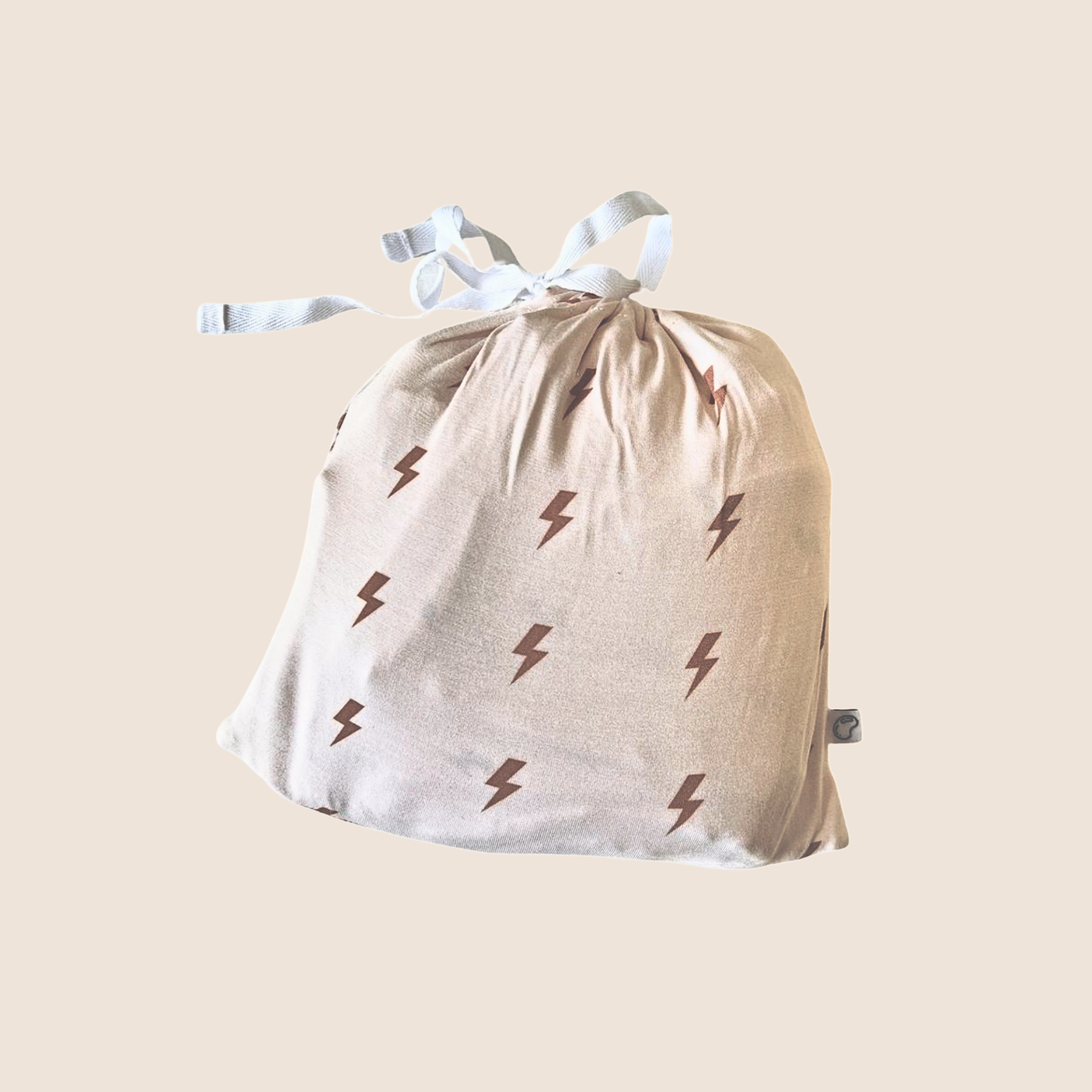 Beige drawstring bag with lightning bolt patterns on a beige background