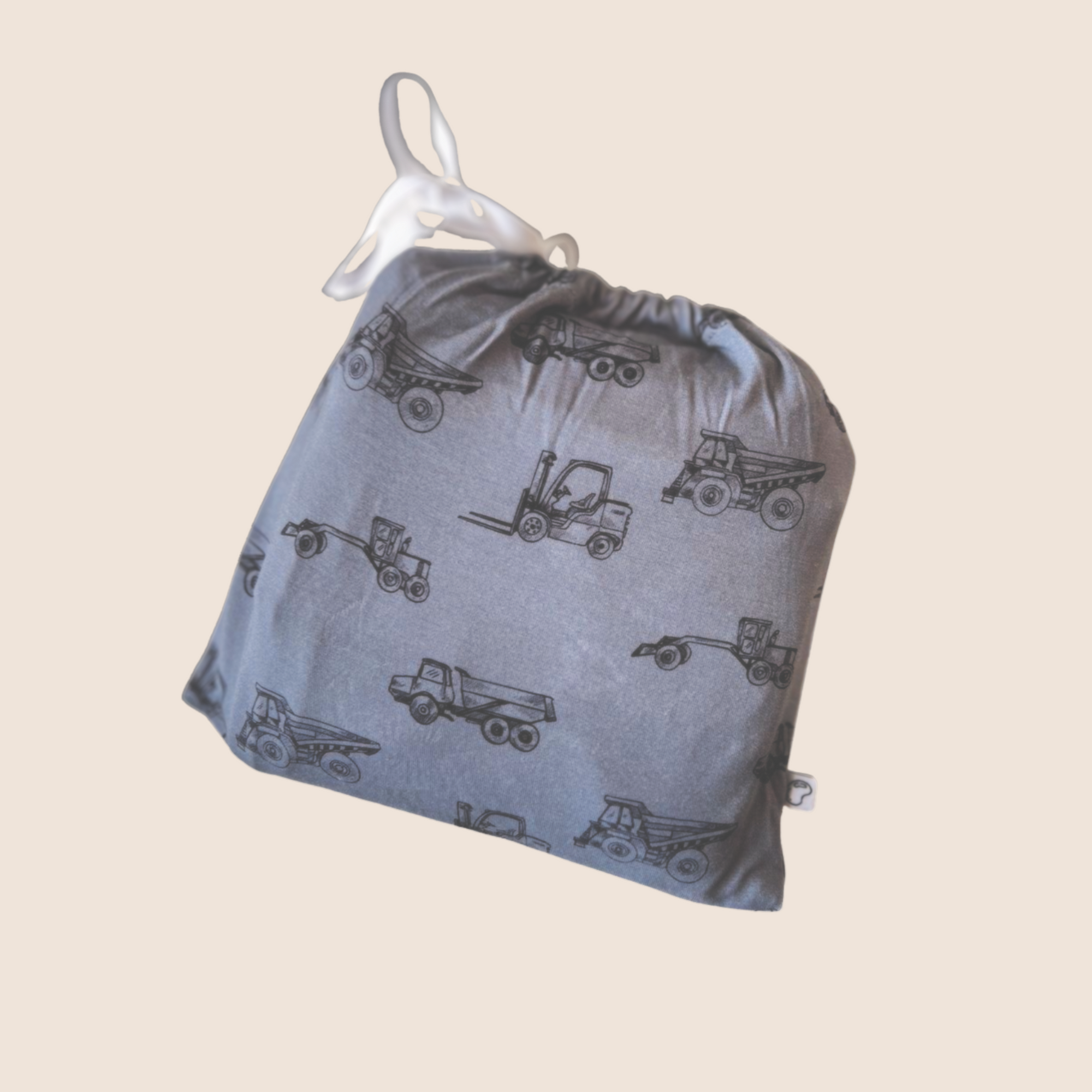 Gray drawstring bag with truck patterns on a beige background